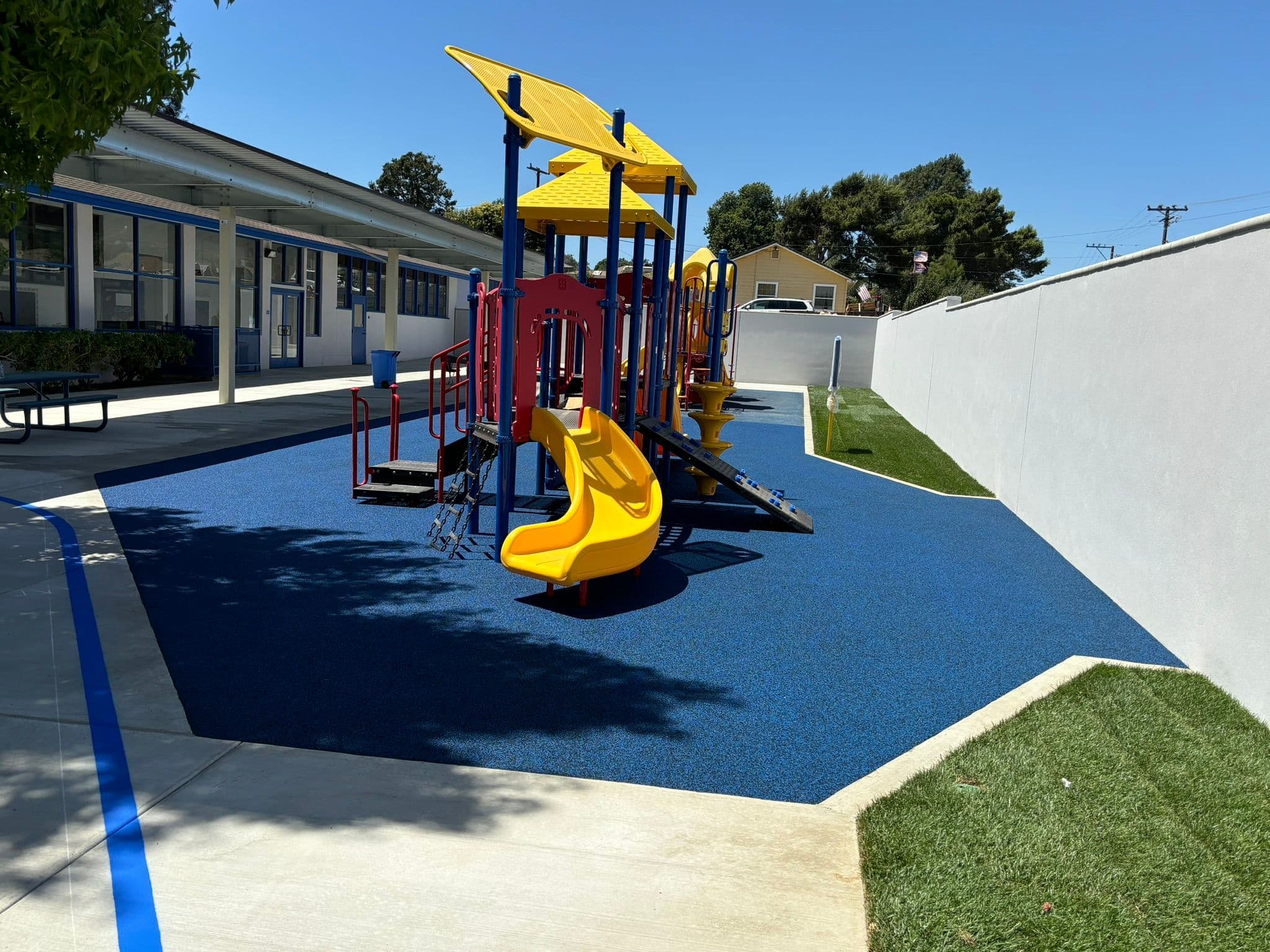 Young Kids School Playground with blue rubber surfacing